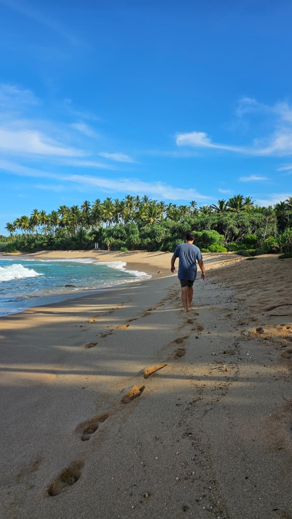 Mathieu marchant sur une plage de la côte sri-lankaise